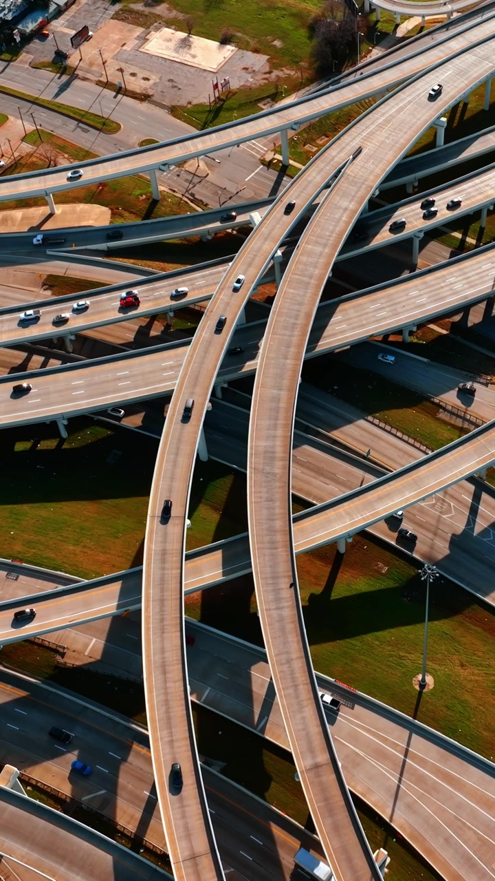 Web of highways and freeways with lively traffic on. Roads of Dallas, Texas, USA from top view. Vertical video