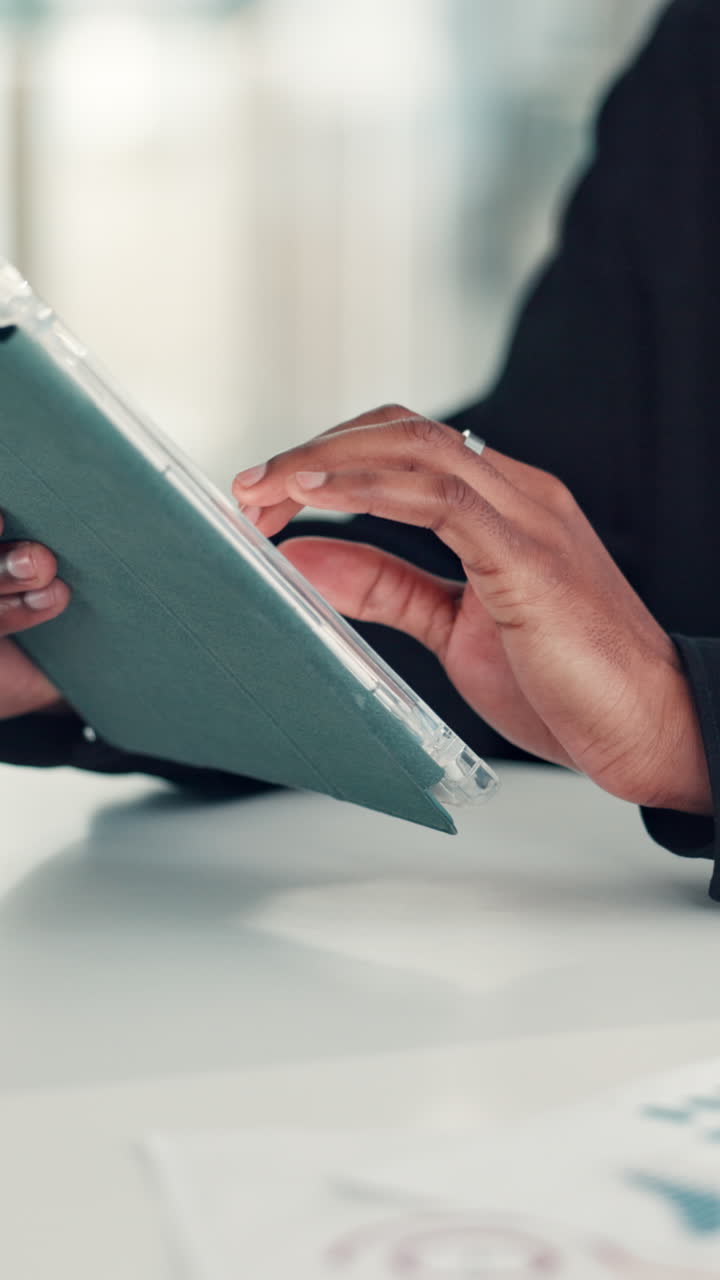 Close-up of Hands Using a Digital Tablet