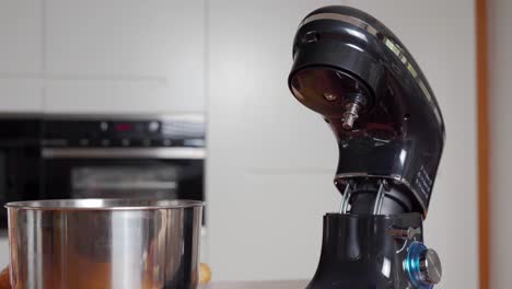 hands showing change of attachment in stand mixer