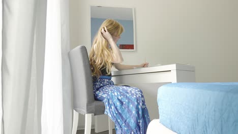 a student girl taking notes at home, a woman learning in covid pandemic