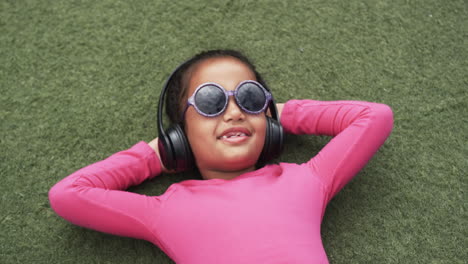 a young african american girl is relaxing at school on a green background