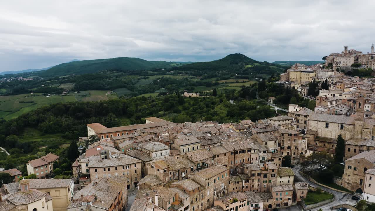 Swooping aerial view of Montepulciano, Tuscany overlooking Italy's green countryside