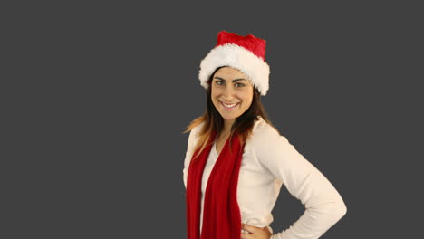 Woman-in-santa-hat-and-warm-clothing-blowing-over-hands-