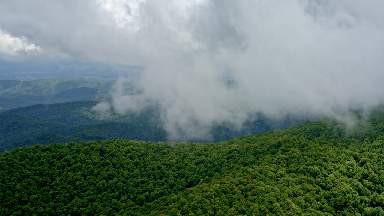 Aerial pass above misty, rain-drenched hills deep in Smoky Mountain country