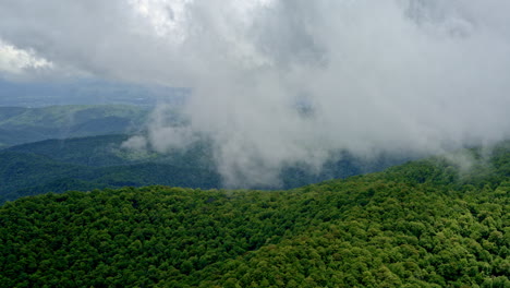 aerial pass above misty, rain-drenched hills deep in smoky mountain country