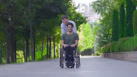 mature man helping disabled man sitting in wheelchair.