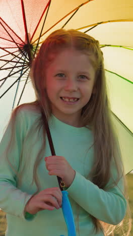 girl smiles spinning umbrella by river. child umbrella creates mesmerizing pattern in air adding touch of whimsy to rainy day. gentle flow of rain