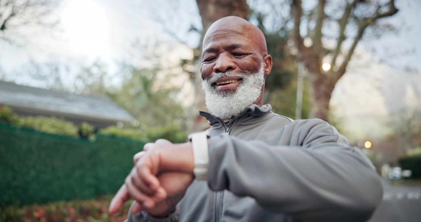 Senior Man Checking Smartwatch During Outdoor Exercise