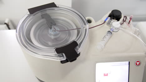 centrifuge machine producing concentrate from blood. plasma extraction with modern equipment. top view.