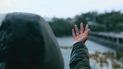 woman catching raindrops in her hands