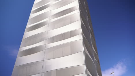 Viewpoint-tower-of-Estepona-city-against-blue-sky,-tilt-down-view