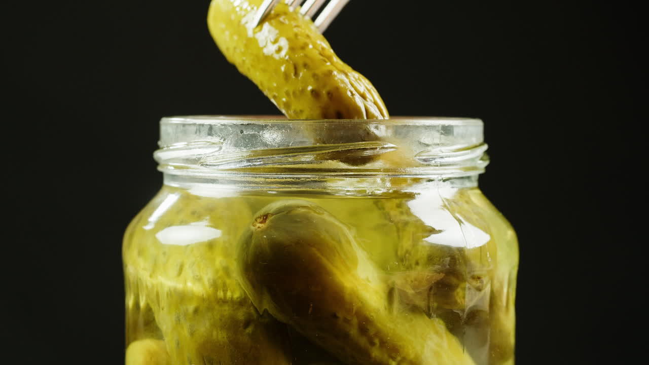 Pickled Cucumbers in a Jar with Fork