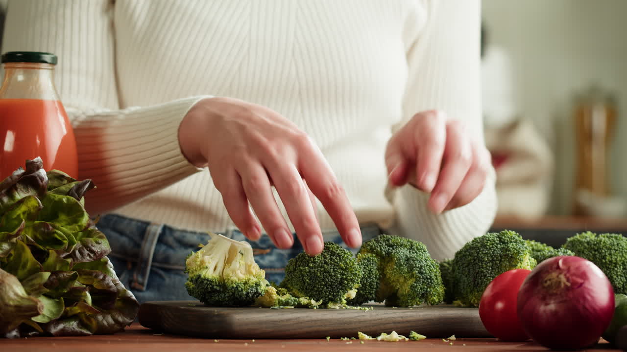Woman Cutting Broccoli for a Healthy Meal
