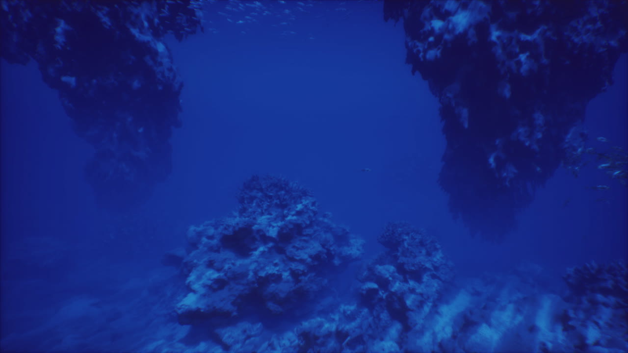 Exploring the deep blue sea beneath majestic underwater rock formations
