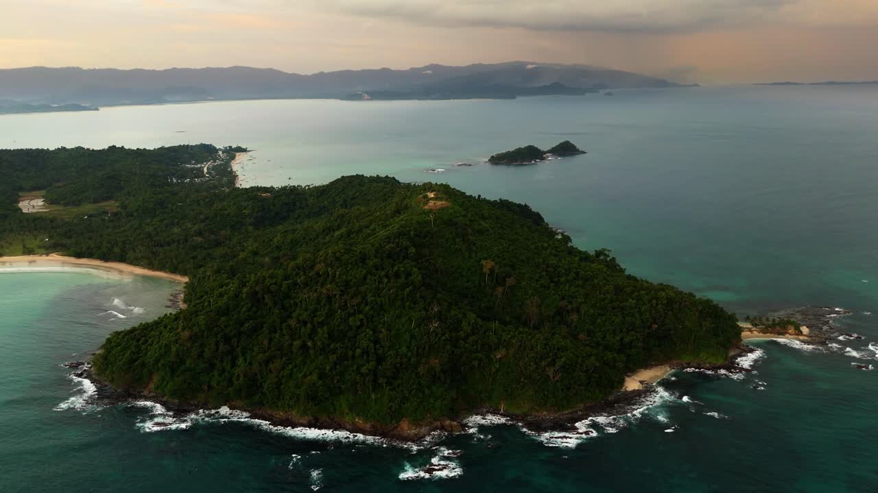 Panoramic drone footage of the San Vicente peninsula in Palawan, Philippines capturing the dramatic sunset secluded beaches and rugged tropical terrain surrounding the famous 100 Steps viewpoint