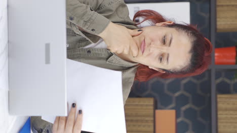 Vertical-video-of-Business-woman-thinks-looking-at-documents.