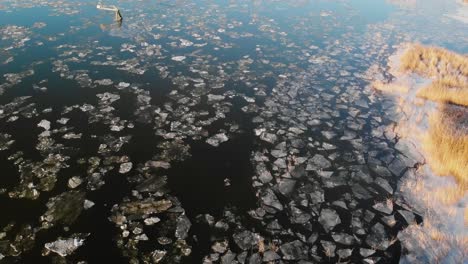Aerial-Scene-Of-Frozen-Lake-In-Early-Spring,-Landscape-Covered-In-Broken-Ice-From-Winter