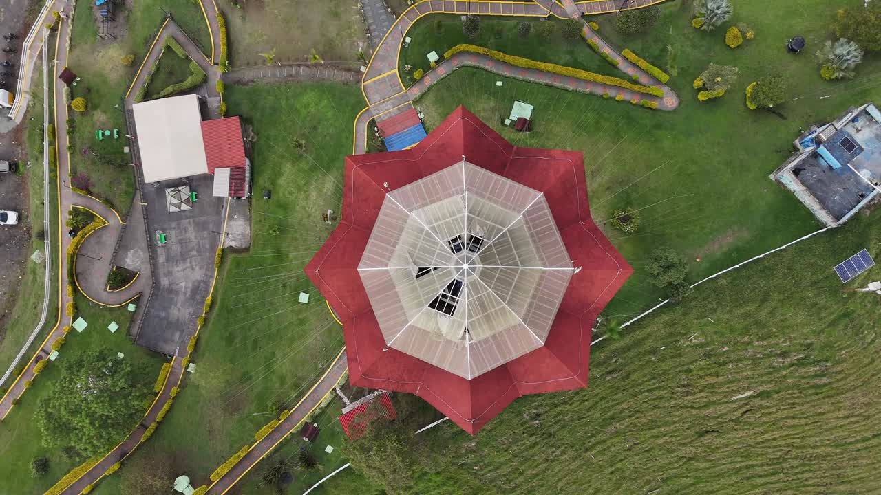 Symmetrical pavilion with red roof and spire