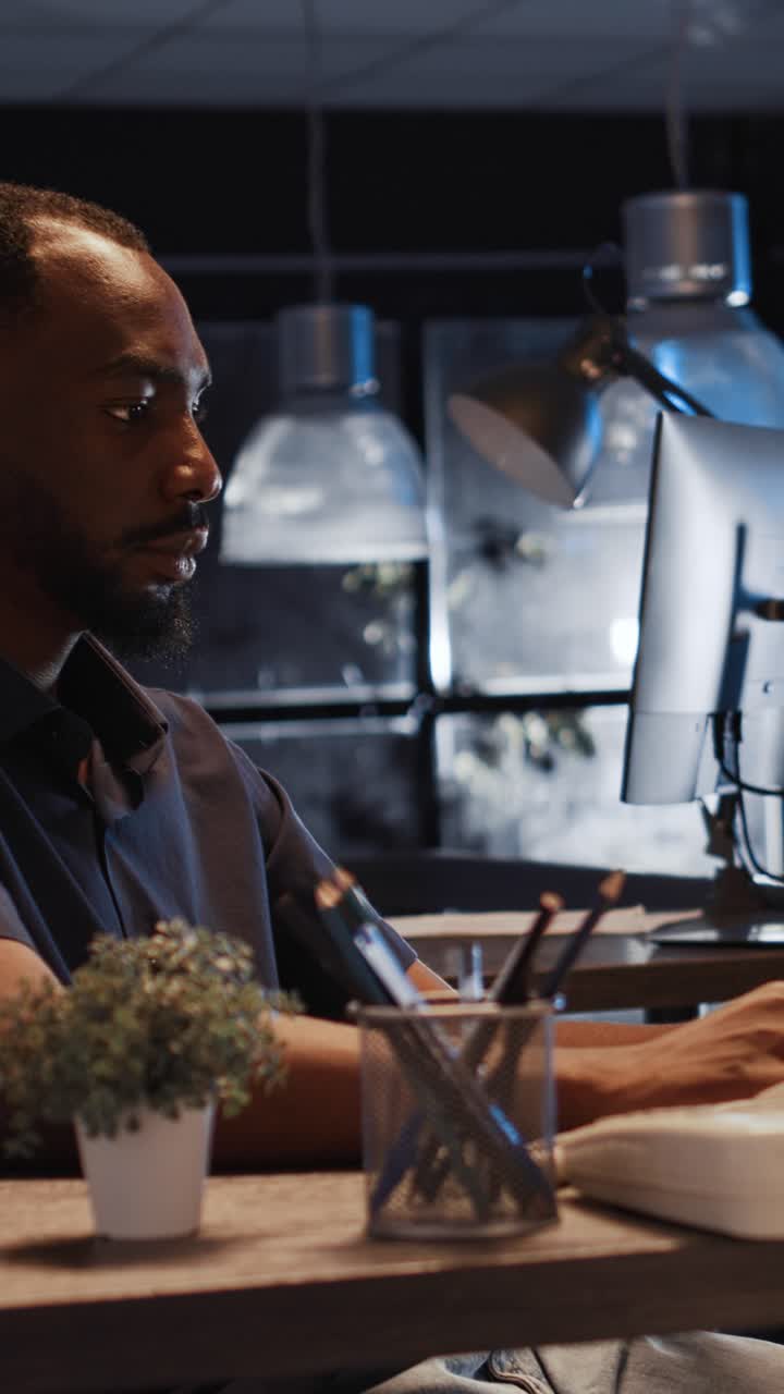 Vertical video: Office worker analyzing startup data on laptop to create project