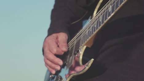 close-up of a person playing an electric guitar