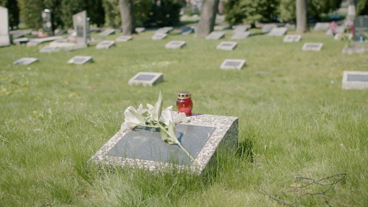 Tombstone With A White Flower And A Grave Candle In A Graveyard On A Sunny Day 3