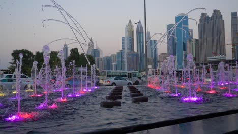 dubai fountains at dusk with city skyline