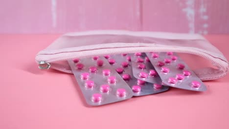 pink pill packets in a pink pouch