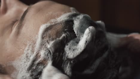 close-up of hair being washed with shampoo and suds