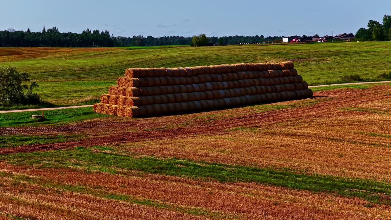 Large haystack on a sunny field, symbolizing harvest and rural life