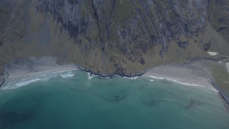 aerial view away from the kvalvika and vestervika beaches, in cloudy lofoten, norway - tilt, drone shot