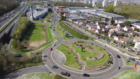 drone shot over roundabout near shopping center in franconville, with paris beltway and traffic - france