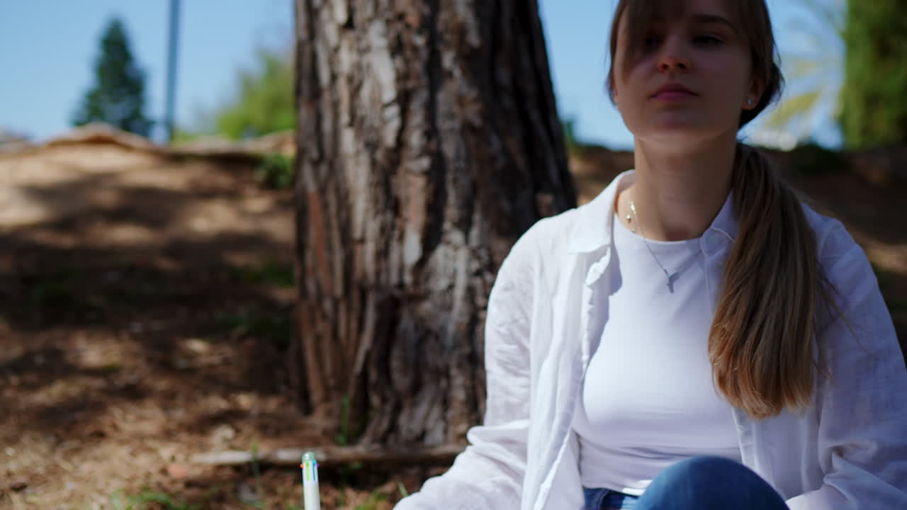 Young Woman Writing Outdoors