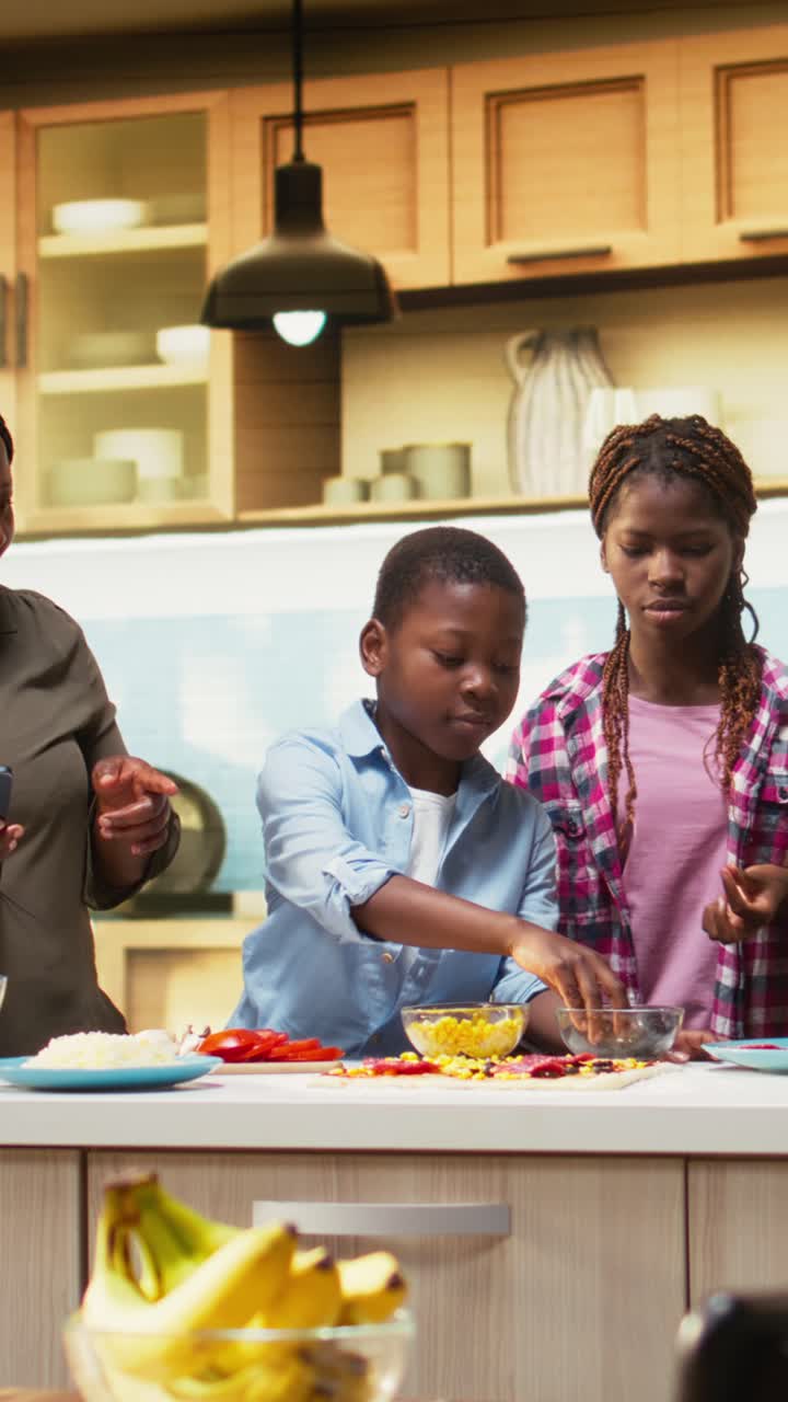 Vertical Video Smiling children following online recipe for pizza with their parents