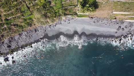 a top down view of the waves coming in to shore in ponta do sol, madeira