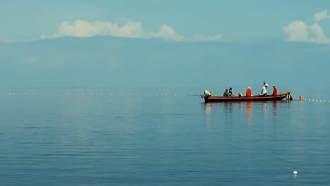 Fisherman-in-action-in-a-water-body-with-blue-sky-in-the-background-in-a-bright-day