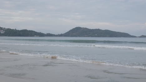 the beach with white sand and calm wave from peaceful sea in summer sunshine daytime