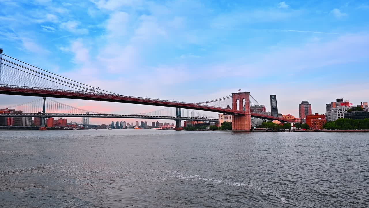 View on the Brooklyn Bridge from the river waterscape. River tour in New York, USA. Low angle perspective
