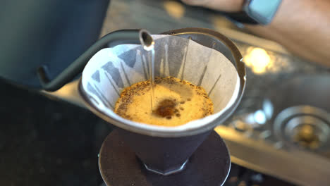 pouring hot water for dripping arabica coffee