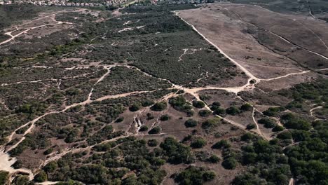 aerial drone slow-motion view of calavera hills - a community in carlsbad california, the northern part of san deigo where this area offers 6+ miles of dirt biking and hiking trails