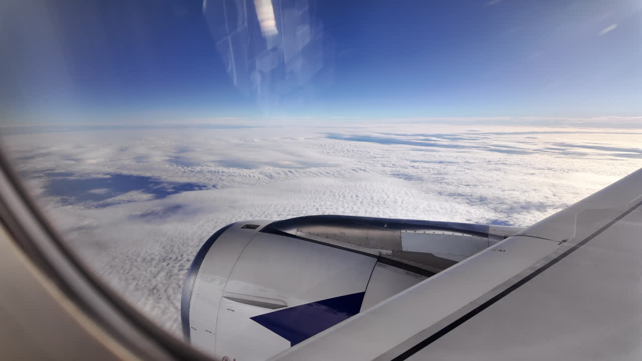 View from an airplane window of the snowed mountains