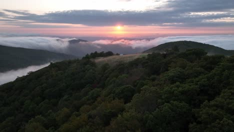 sunrise aerial with farm cabin, mountain cabin in the background near sampson nc, near boone and blowing rock nc, north carolina