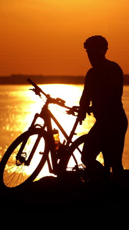 rider resting on cycling trip in nature. mountain biker looking at view on bike trail vertical video