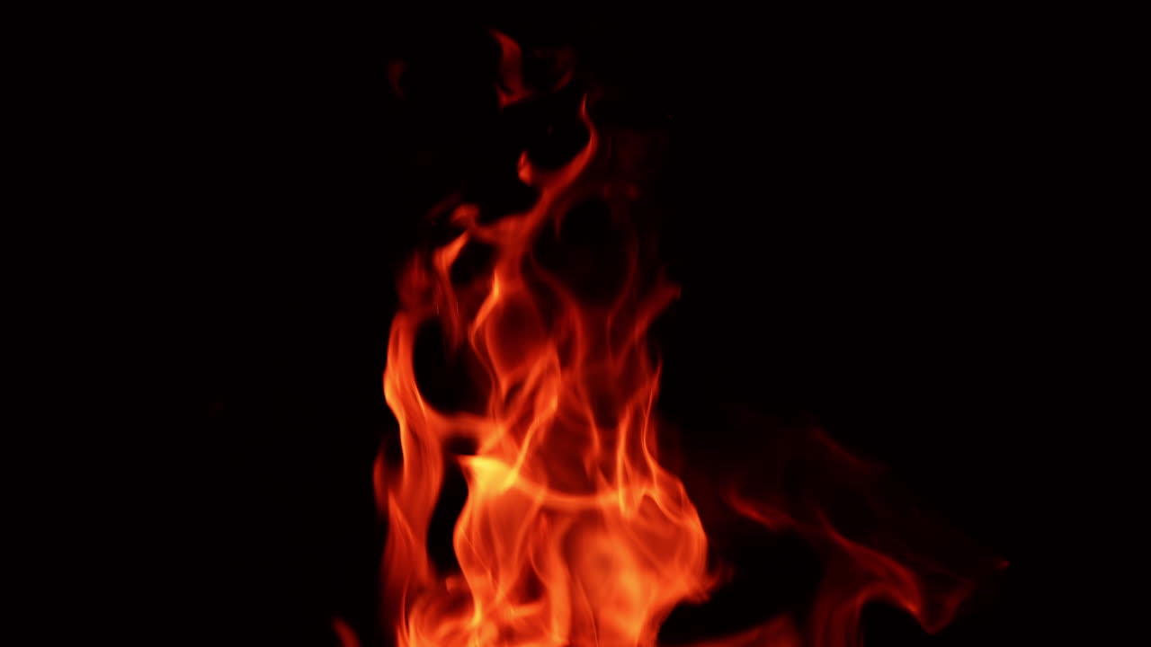 Top part of the bonfire burning at night. Hot dangerous flame isolated close up.