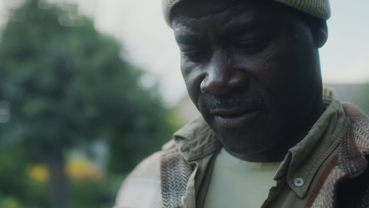 African American Farmer Looking at Fresh Vegetables