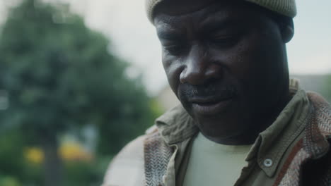 african american farmer looking at fresh vegetables