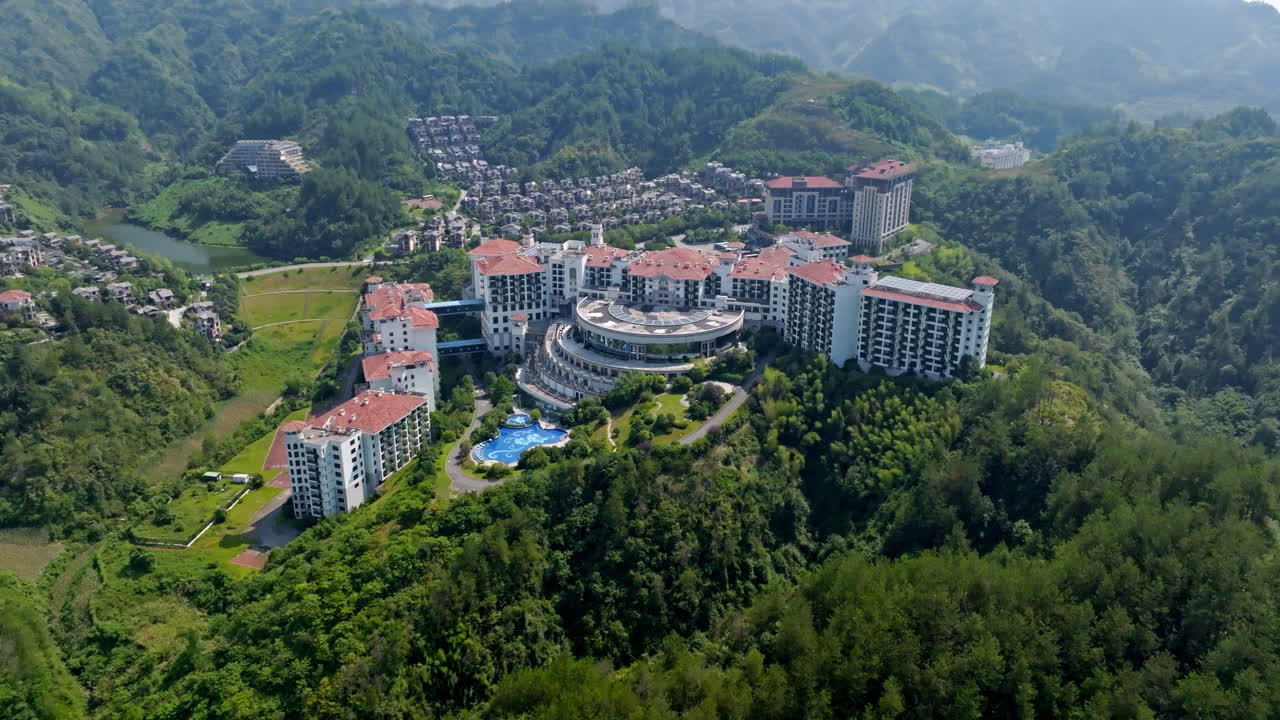 Establishing drone shot circling an enourmous hotel complex, summer in China