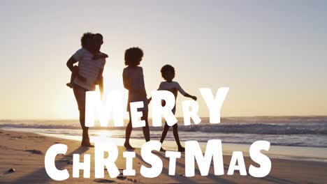 animation of merry christmas text over happy african american family walking on sunny beach