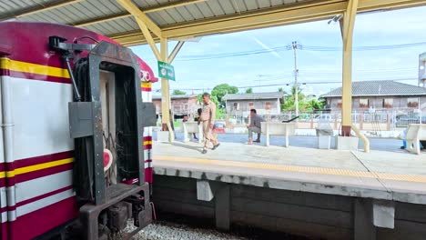 train leaving station with waving conductor