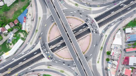 time-lapse of car traffic transportation above roundabout road. drone aerial top view. public transport or commuter city life concept. zoom out