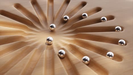 wooden surface with radial paths and metal balls